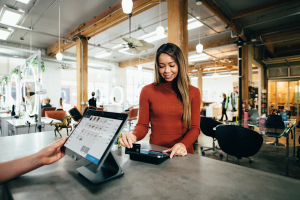 Store manager using digital tablet at billing counter